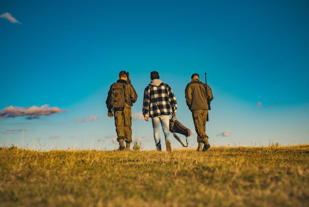 Na zjdęciu trzech mężczyzn, myśliwych